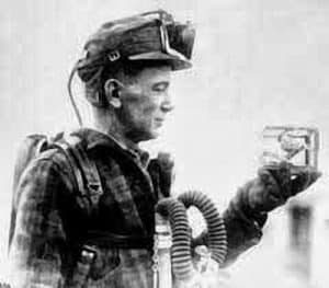 coal miner holding canary in small cage