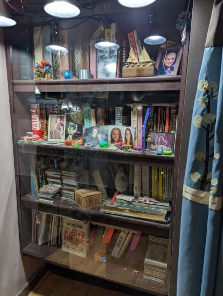 Bookcase sealed by plexiglass against fethers, dander and seed.